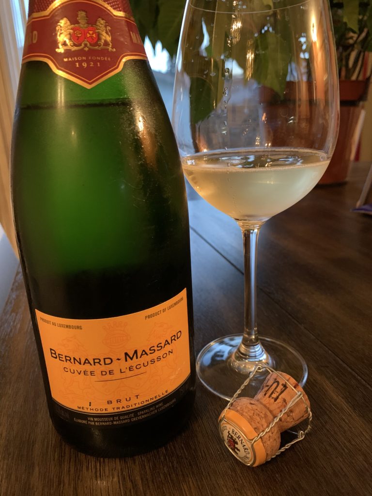 a bottle and glass of sparkling wine